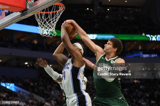 Brook Lopez of the Milwaukee Bucks blocks a shot by Wendell Carter Jr. #34 of the Orlando Magic during the second half of a game at Fiserv Forum on...