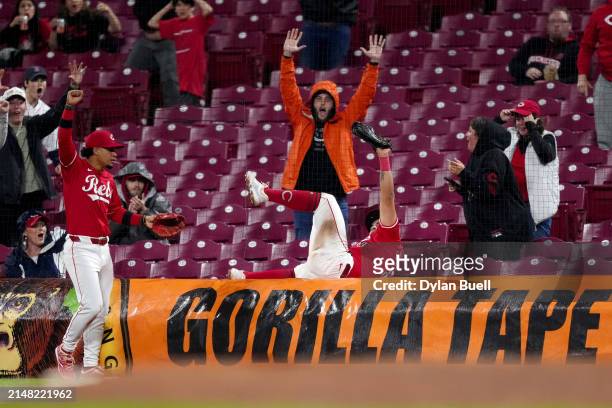Fans celebrate after Christian Encarnacion-Strand of the Cincinnati Reds caught a foul ball in the ninth inning against the Milwaukee Brewers at...