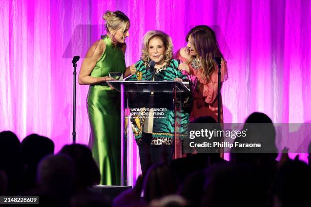 Honoree Wallis Annenberg accepts the Unsung Hero Award from Jamie Alexander Tisch and Rita Wilson onstage during "An Unforgettable Evening"...