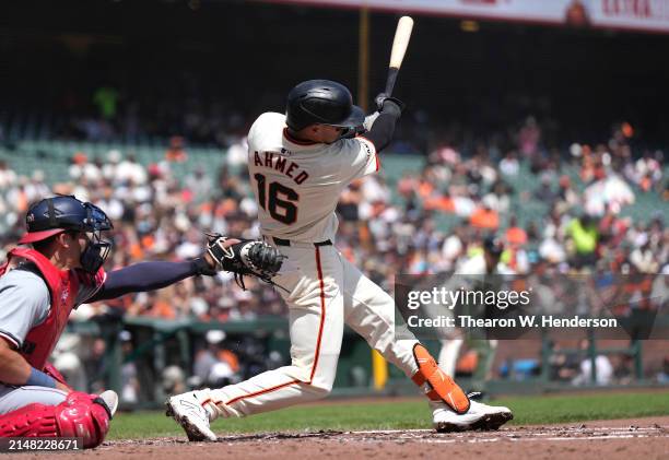 Nick Ahmed of the San Francisco Giants hits an rbi triple scoring Matt Chapman against the Washington Nationals in the bottom of the second inning of...