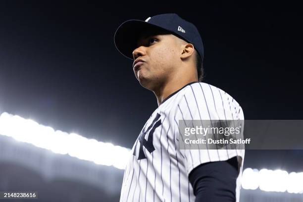 Juan Soto of the New York Yankees walks off the field at the end of the fifth inning of the game against the New York Yankees at Yankee Stadium on...