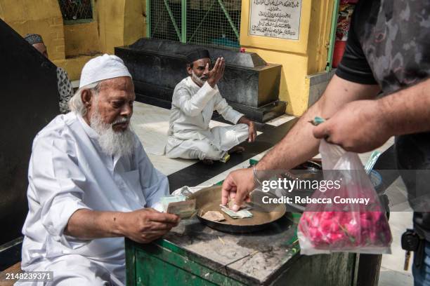 Muslims leave offerings during celebrations to mark Eid Al-Fitr at the Hazrat Nizamuddin Dargah on April 11, 2024 in Delhi, India. Muslims worldwide...