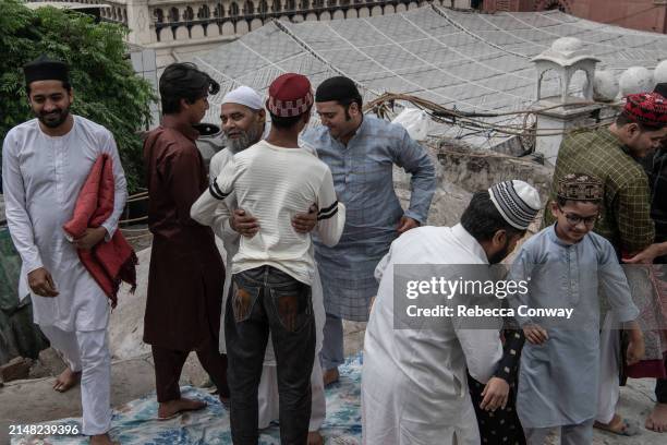 Muslims offer greetings following Eid Al-Fitr prayers at the Hazrat Nizamuddin Dargah on April 11, 2024 in Delhi, India. Muslims worldwide observe...