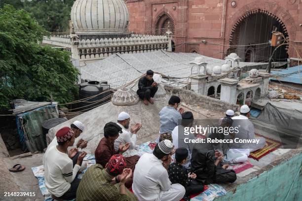 Muslims perform Eid Al-Fitr prayers at the Hazrat Nizamuddin Dargah on April 11, 2024 in Delhi, India. Muslims worldwide observe the Eid Al-Fitr...