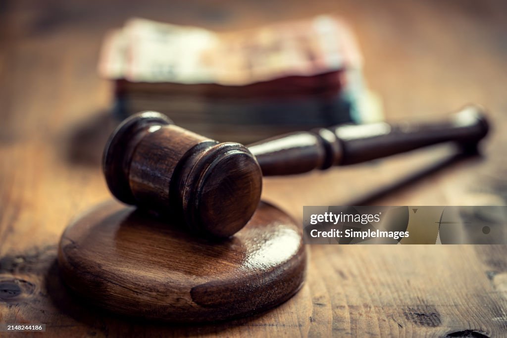 Corruption in the judiciary, the judge's gavel and euro banknotes in an envelope.