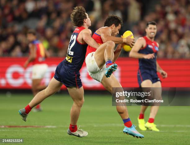 Cam Rayner of the Lions marks in front of Tom Sparrow of the Demons during the round five AFL match between Melbourne Demons and Brisbane Lions at...