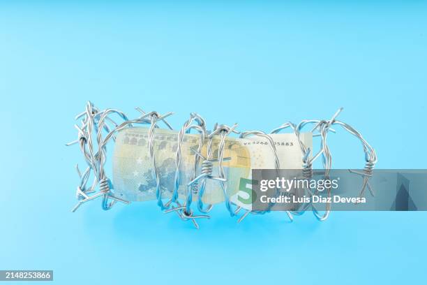 5 euro bill banknote in barbed wire. - e safety stock pictures, royalty-free photos & images