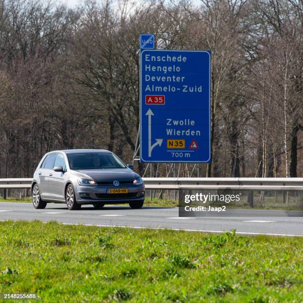 dutch gray 2013 volkswagen golf driving on the n36 - golf imagens e fotografias de stock