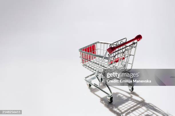 empty shopping cart on white background - outlet store stock pictures, royalty-free photos & images