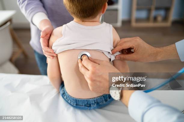 unrecognizable pediatrician examining boy's lungs with an stethoscope - lunga bildbanksfoton och bilder