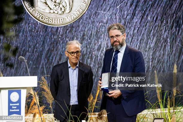 Founder Eliot Higgins of research collective Bellingcat receives the award from Derk Sauer at the the Four Freedom Award Ceremony at the Abbey on...