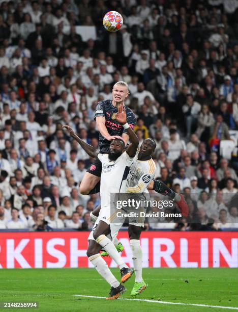 Erling Haaland of Manchester City competes for a high ball with Antonio Rudiger and Ferland Mendy of Real Madrid CF during the UEFA Champions League...