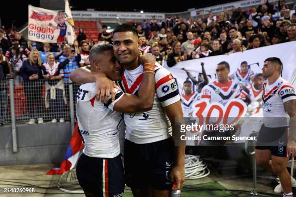 Michael Jennings of the Roosters celebrates playing 300 games with Daniel Tupou of the Roosters after winning the round six NRL match between...