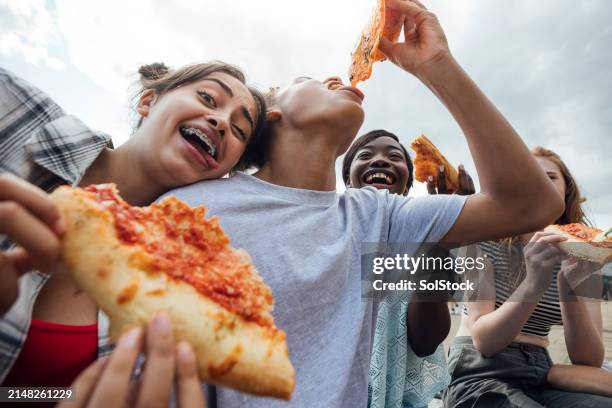 eating pizza and funny faces - black girl with red hair stock pictures, royalty-free photos & images