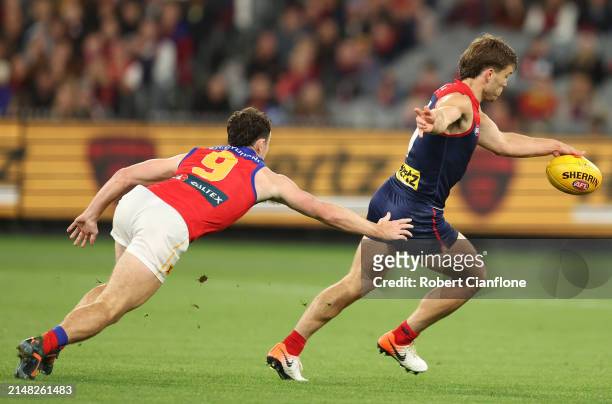 Jack Viney of the Demons is pressured by Lachie Neale of the Lions during the round five AFL match between Melbourne Demons and Brisbane Lions at...