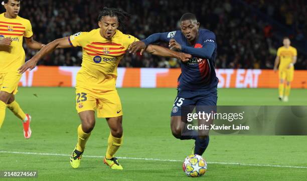 Jules Kounde of FC Barcelona in action with Nuno Mendes of Paris Saint-Germain play the ball during the UEFA Champions League quarter-final first leg...