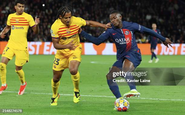 Jules Kounde of FC Barcelona in action with Nuno Mendes of Paris Saint-Germain play the ball during the UEFA Champions League quarter-final first leg...
