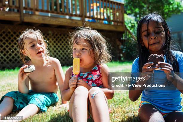 multiracial group of friends eating ice cream outside on summer afternoon - hot american girl stock pictures, royalty-free photos & images