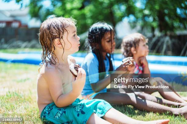 multiracial group of friends eating ice cream outside on summer afternoon - chinese eating backyard stock pictures, royalty-free photos & images