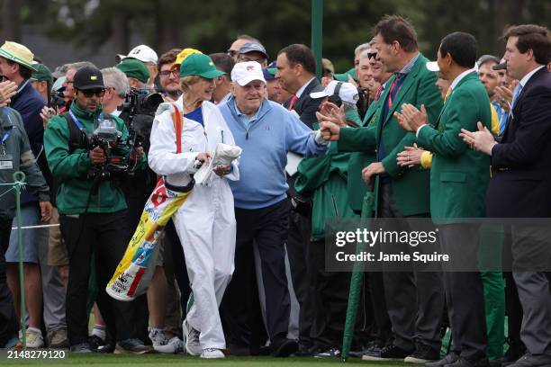 Jack Nicklaus of the United States and his wife Barbara Nicklaus greet Sir Nick Faldo of England on the first tee during the Honorary Starters...