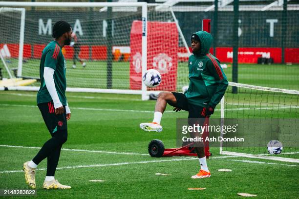 Casemiro and Kobbie Mainoo of Manchester United in action during a first team training session at Carrington Training Ground on April 10, 2024 in...