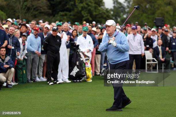 Jack Nicklaus of The United States plays his tee shot in the Honorary Starters ceremony watched by Gary Player of South Africa and Tom Watson of The...