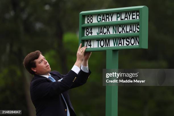 Member of the Augusta National staff places the names of the players into the first tee players name display for the Honorary Starters ceremony with...