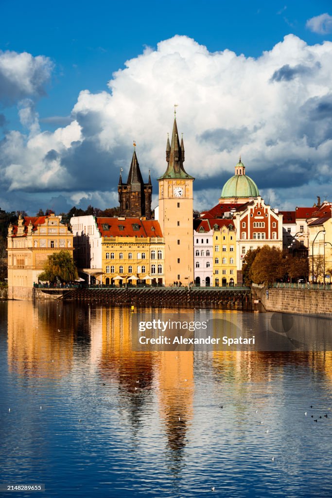 Towers of Prague old town reflecting in Vltava river, Czech Republic