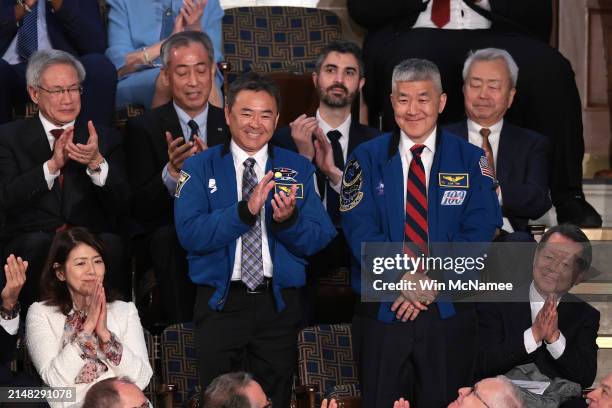 Astronaut Daniel Tani and Akihiko Hoshide stand as they are recognized by Japanese Prime Minister Fumio Kishida as he addresses a joint meeting of...