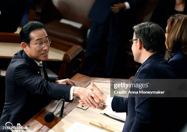 Japanese Prime Minister Fumio Kishida shakes hands with U.S. Vice President Kamala Harris and U.S. Speaker of the House Mike Johnson after he...