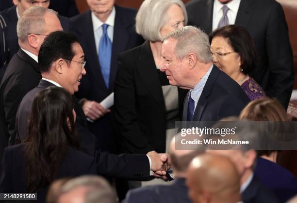 Japanese Prime Minister Fumio Kishida greets Sen. Richard Durbin as he departs after addressing a joint meeting of Congress in the House of...