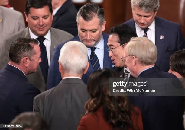 Japanese Prime Minister Fumio Kishida greets lawmakers as he departs after addressing a joint meeting of Congress in the House of Representatives at...