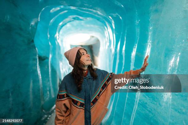 woman exploring ice cave - cantão de valais imagens e fotografias de stock