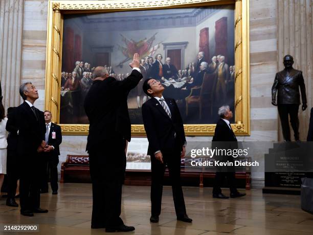 Japanese Prime Minister Fumio Kishida stands in front of a painting of the signing of the Declaration of Independence as he tours the Rotunda of the...