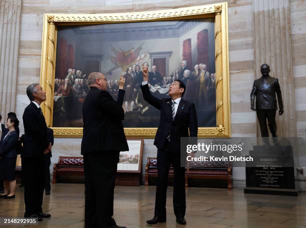 Japanese Prime Minister Fumio Kishida stands in front of a painting of the signing of the Declaration of Independence as he tours the Rotunda of the...