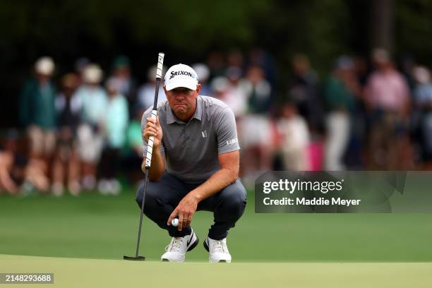 Lucas Glover of the United States lines up a putt on the first green during the first round of the 2024 Masters Tournament at Augusta National Golf...