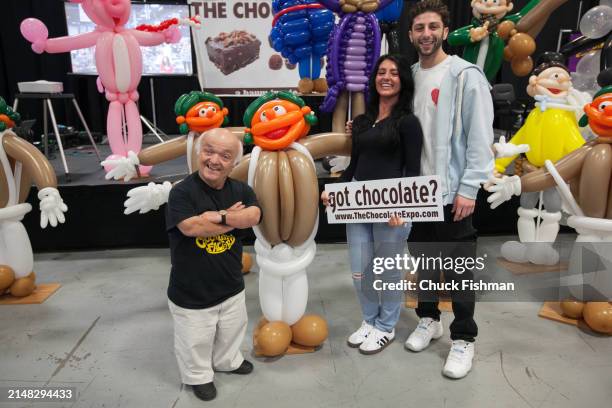 Portrait of English actor Rusty Goffe and others pose together as they attend an event related to the film 'Willie Wonka and the Chocolate Factory'...