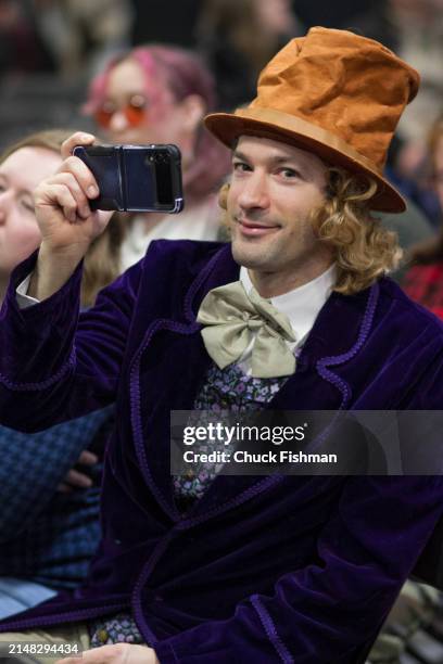 Portrait of an unidentified man as he holds up a smart phone during an event related to the film 'Willie Wonka and the Chocolate Factory' at the...