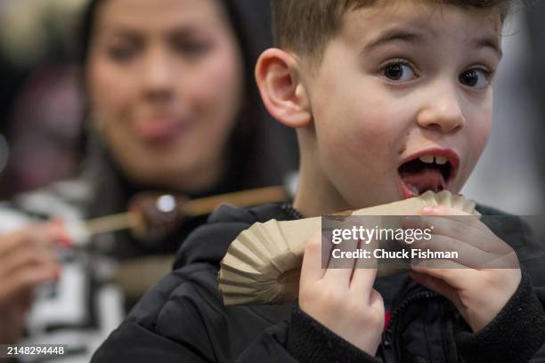 Close-up of an unidentified young boy as he licks during the Chocolate Expo in the New Jersey Expo Center, Edison, New Jersey, March 10, 2024.