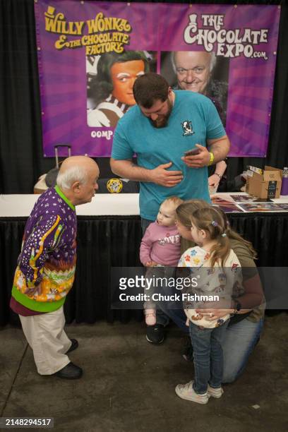 English actor Rusty Goffe speaks with several people, including two children, during an event related to the film 'Willie Wonka and the Chocolate...
