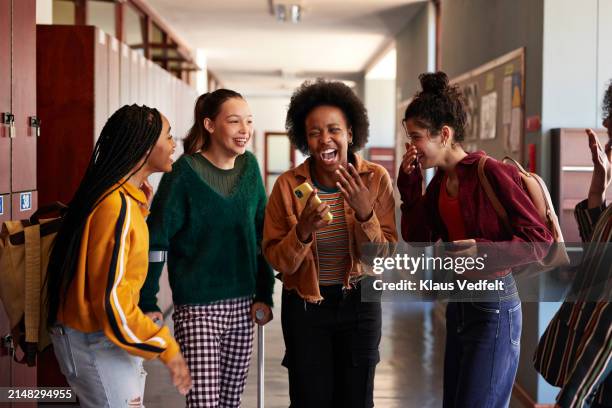 cheerful friends discussing in hallway - teenagers only stock pictures, royalty-free photos & images