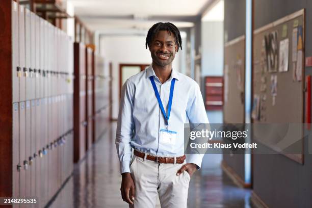 smiling male teacher standing with hand in pocket - shirt pocket stock pictures, royalty-free photos & images