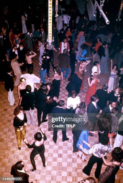 An above angle of people dancing at the Manhattan nightclub and disco Studio 54 in New York, New York, circa 1979.