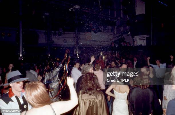 Group of people dance with snow flakes falling from the ceiling at the Manhattan nightclub and disco Studio 54 in New York, New York, circa 1979.