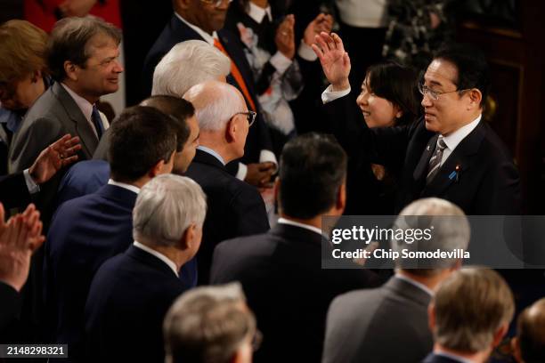 Japanese Prime Minister Fumio Kishida waves goodbye to lawmakers after he addressed a joint meeting of Congress in the House of Representatives at...