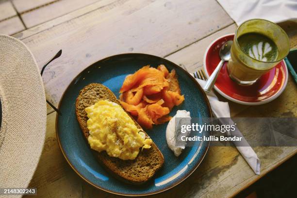 woman having healthy breakfast in cafe - scrambled eggs stock pictures, royalty-free photos & images