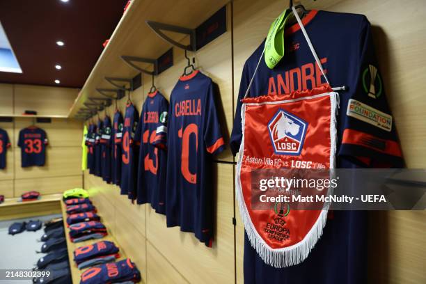 Detailed view of the match pennant is displayed with the shirt of Benjamin Andre and UEFA Respect Captain's Armband inside the Lille dressing room...