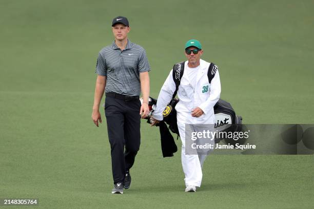 Cameron Davis of Australia walks the second fairway with his caddie, Andrew Tschudin during the first round of the 2024 Masters Tournament at Augusta...