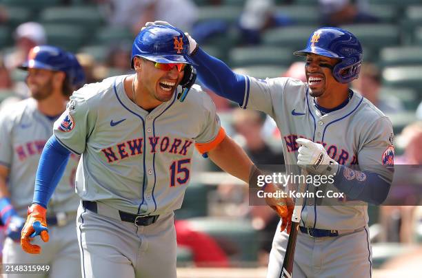 Tyrone Taylor of the New York Mets reacts with Francisco Lindor after hitting a grand slam in the ninth inning against the Atlanta Braves at Truist...