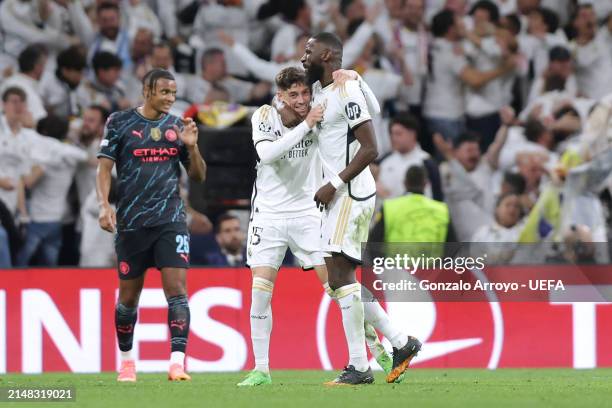 Federico Valverde of Real Madrid CF celebrates scoring their third goal with teammate Antonio Rudiger as Manual Akanji of Manchester City FC reacts...